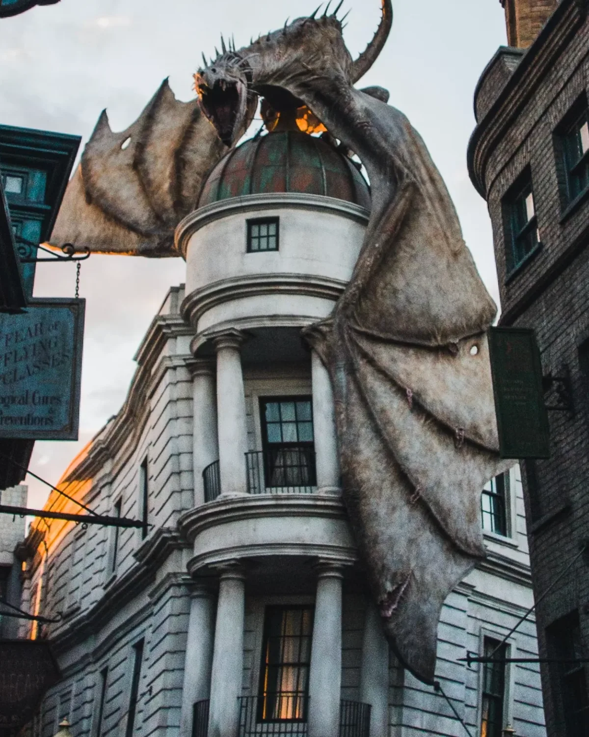 A dragon perched on the domed roof of a white bank building