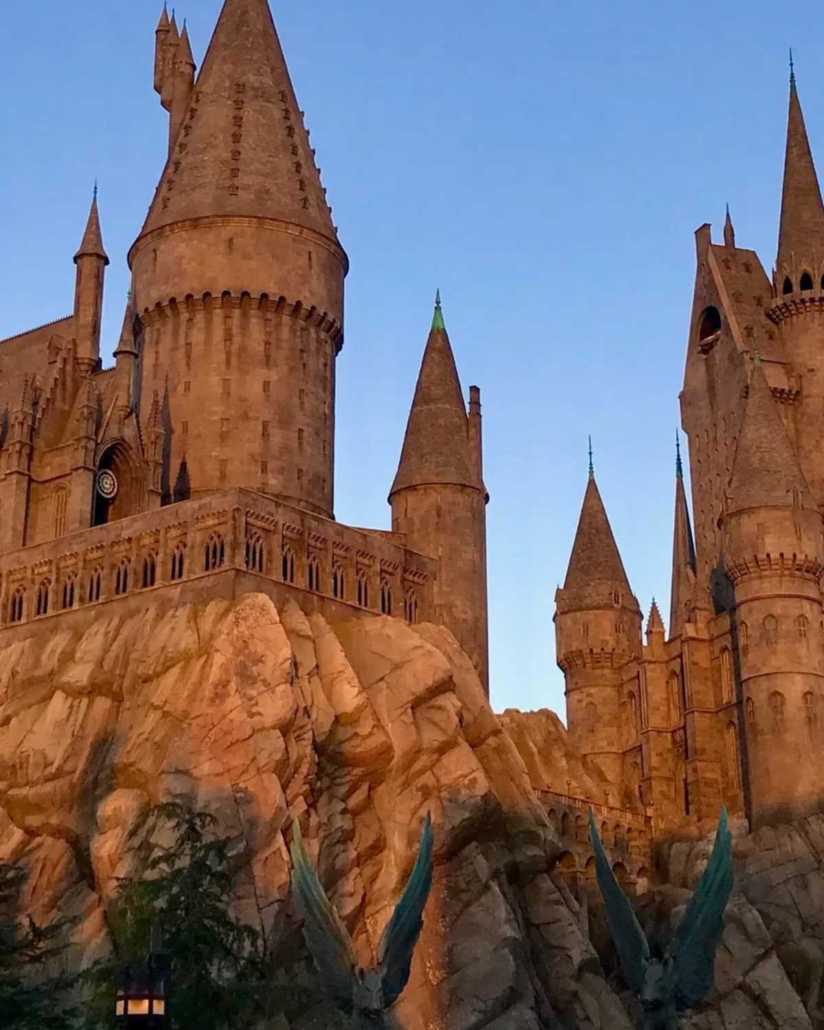 A castle of towers and spires glowing at dusk