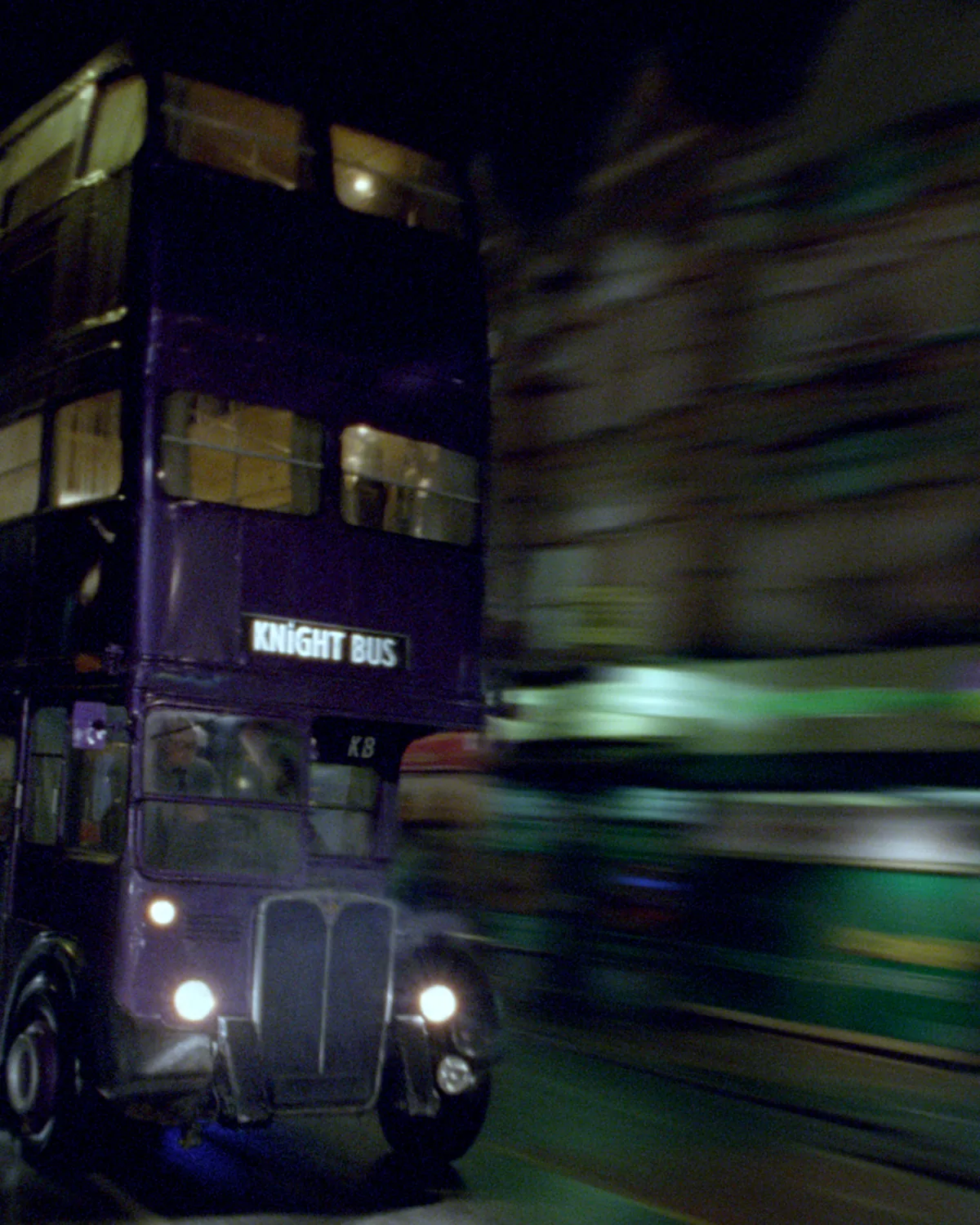 The purple triple-decker Knight Bus streaking through the night