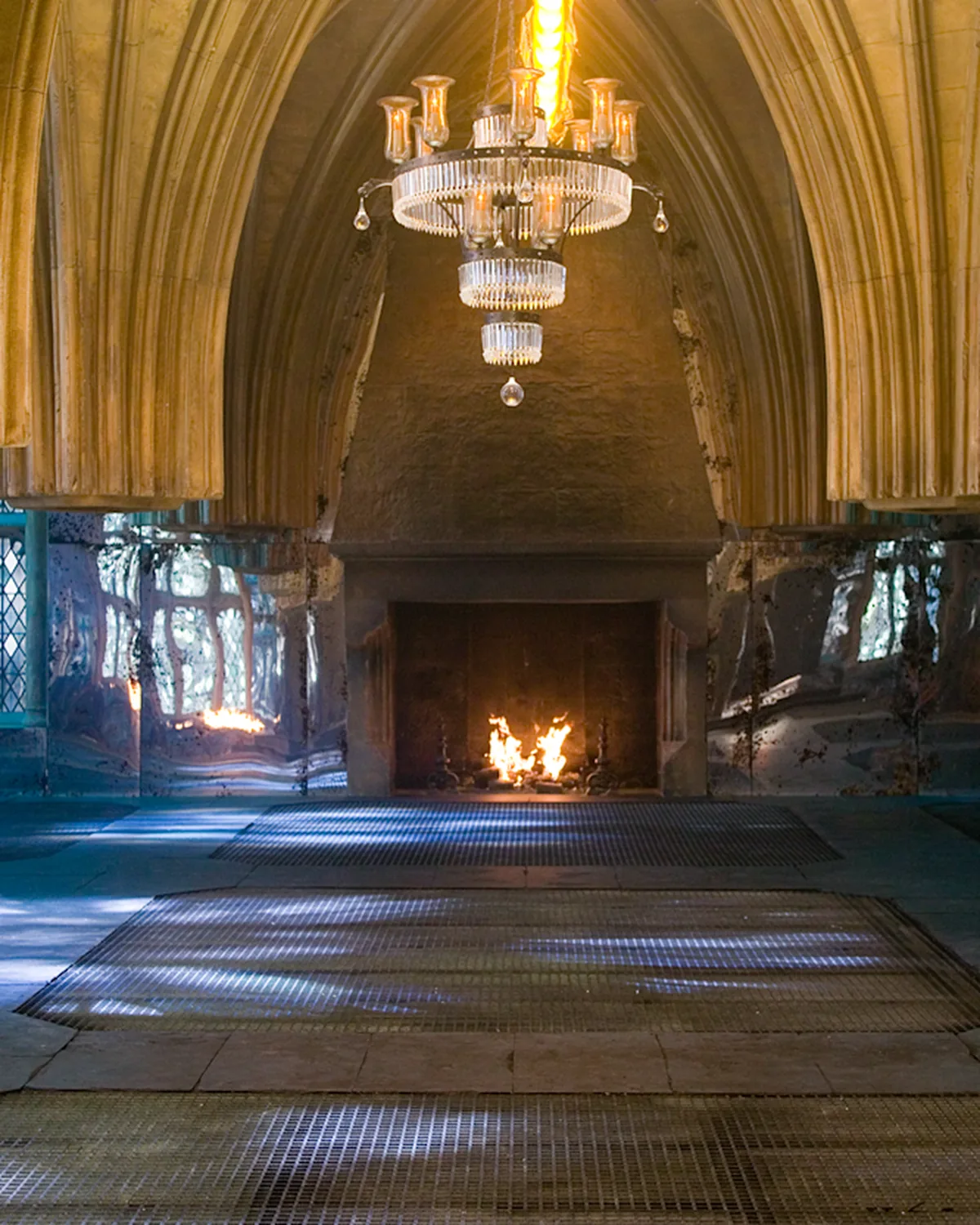 The Room of Requirement, tapestries and a chandelier over a long hall